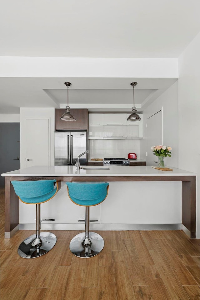 214 N 11th St Unit 1X, New York City, NY 11211 - kitchen featuring stainless steel appliances, light countertops, and wood finished floors