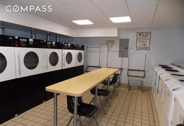 837 Washington Ave Unit 4B, New York City, NY 10451 - community laundry room with washing machine and clothes dryer, electric panel, and light tile patterned floors