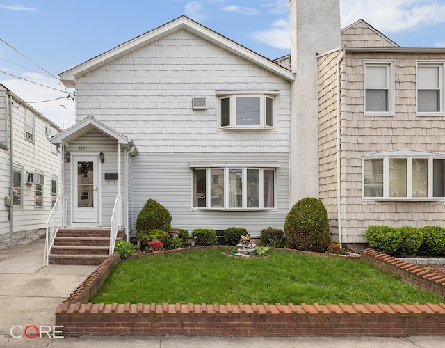 3707 Quentin Rd, New York City, NY 11234 - view of front of house featuring entry steps, a chimney, and a front yard