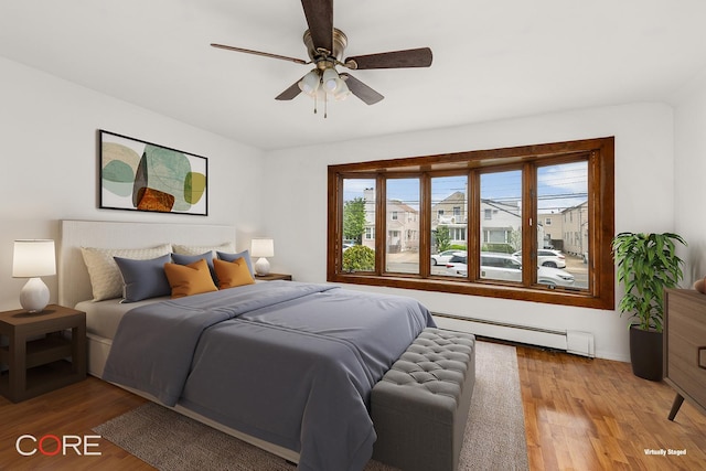 3707 Quentin Rd, New York City, NY 11234 - bedroom featuring a baseboard radiator, light wood-style floors, ceiling fan, and baseboards