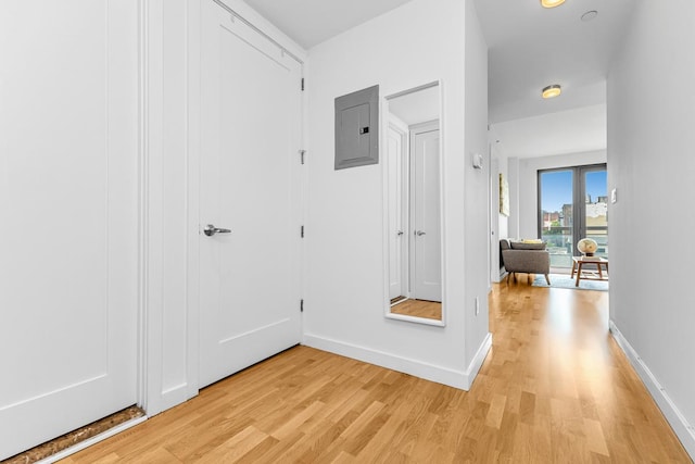 500 4th Ave Unit 5F, New York City, NY 11215 - hallway featuring electric panel, light wood-style flooring, and baseboards