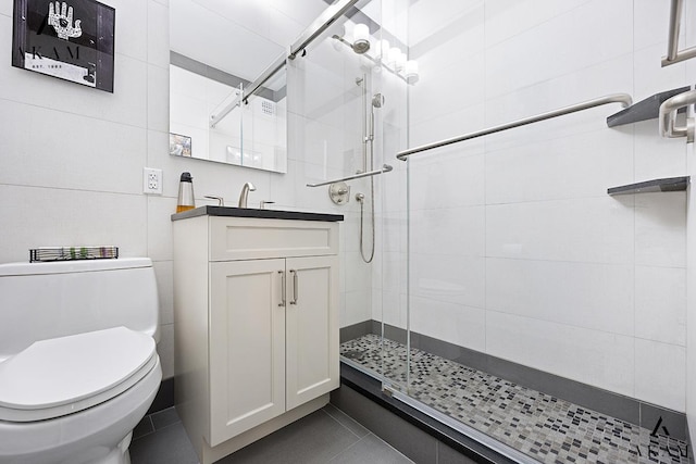 300 E 74th St Unit 15-E, New York City, NY 10021 - full bath with vanity, toilet, tile patterned floors, and tiled shower
