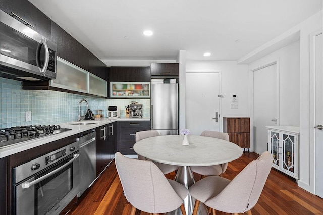 185 13th St Unit 3-B, New York City, NY 11215 - kitchen featuring stainless steel appliances, a sink, decorative backsplash, glass insert cabinets, and light countertops