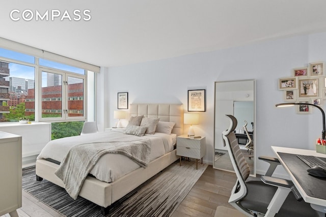 385 1st Ave Unit 6B, New York City, NY 10010 - bedroom with wood finished floors and a view of city
