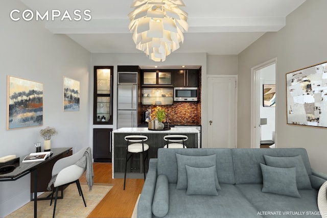 325 W 45th St Unit 700, New York City, NY 10036 - living area featuring light wood-type flooring, a chandelier, and beamed ceiling