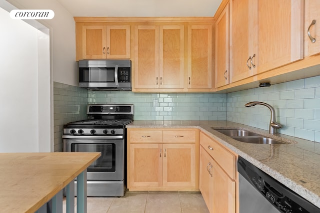 201 E 25th St Unit 9H, New York City, NY 10010 - kitchen featuring stainless steel appliances, light brown cabinetry, a sink, light tile patterned floors, and tasteful backsplash