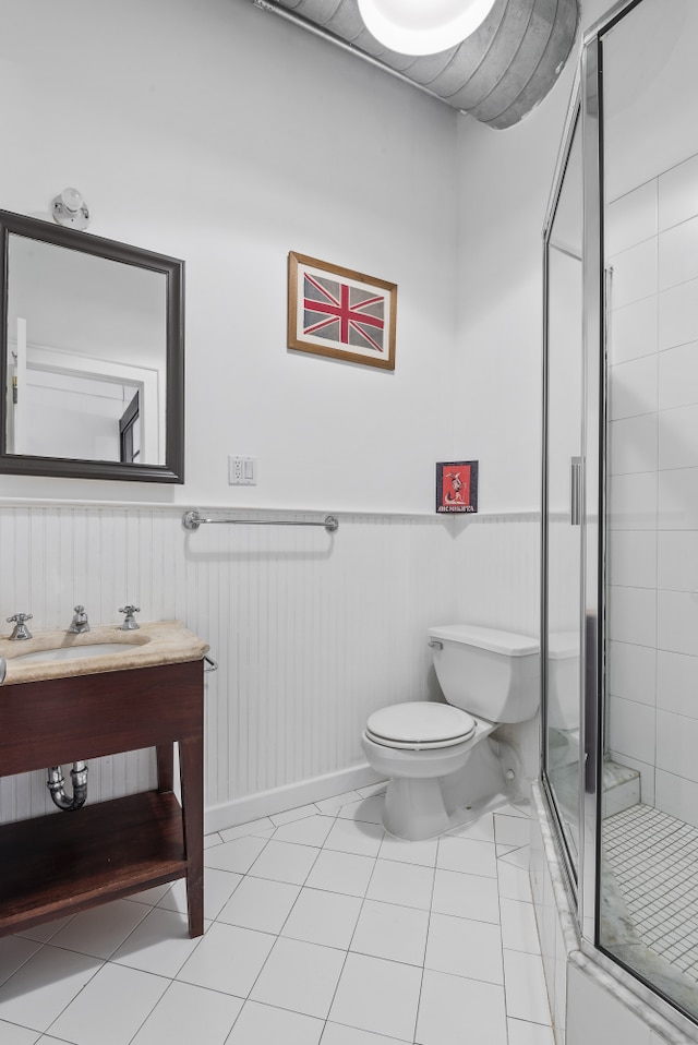 114 Mercer St Unit Unit2, New York City, NY 10012 - bathroom with a stall shower, a wainscoted wall, vanity, and tile patterned flooring