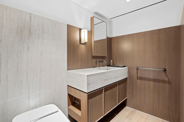 799 Park Ave Unit 19/20B, New York City, NY 10021 - bathroom with toilet, vanity, and wood finished floors