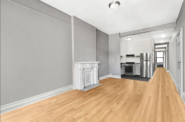 24 W 126th St, New York City, NY 10027 - unfurnished living room featuring light wood-style flooring and baseboards