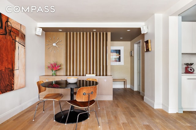 360 W 22nd St Unit 5M, New York City, NY 10011 - dining space featuring baseboards and light wood-type flooring