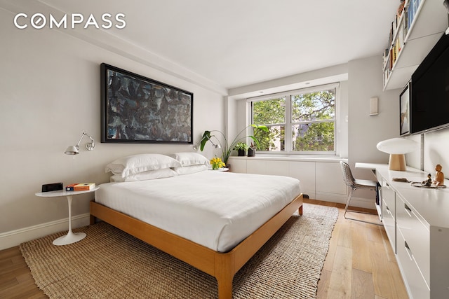 360 W 22nd St Unit 5M, New York City, NY 10011 - bedroom featuring light wood-style floors and baseboards