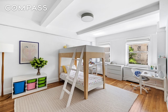 49 E 96th St Unit 4D, New York City, NY 10128 - bedroom featuring beamed ceiling, a desk, and light wood-type flooring