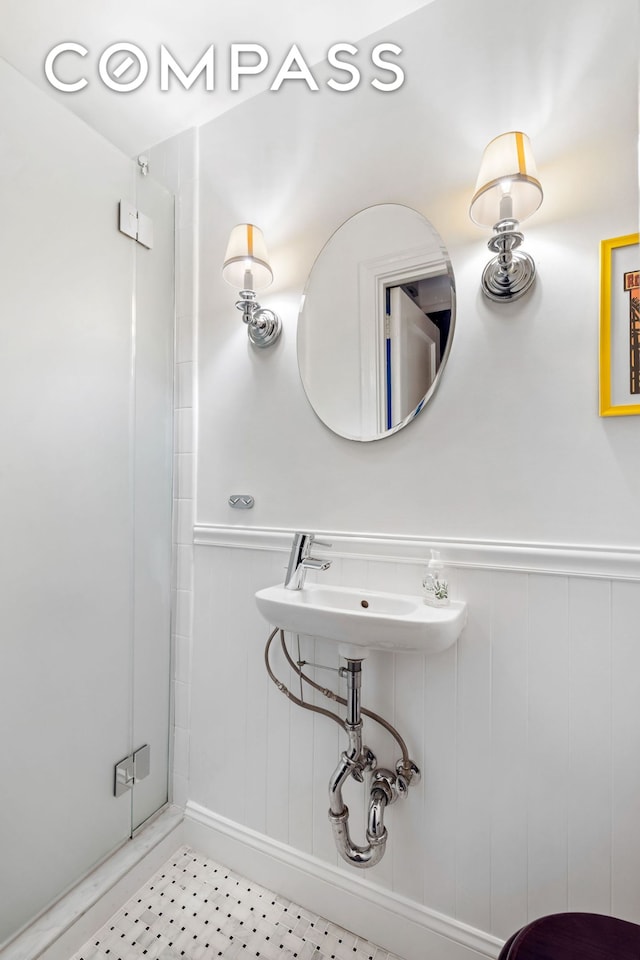 49 E 96th St Unit 4D, New York City, NY 10128 - bathroom featuring a wainscoted wall and a sink