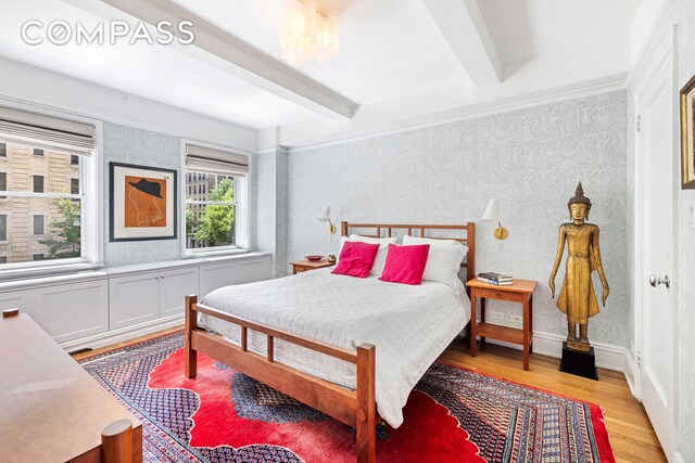 49 E 96th St Unit 4D, New York City, NY 10128 - bedroom with light wood-style flooring, wallpapered walls, and beamed ceiling