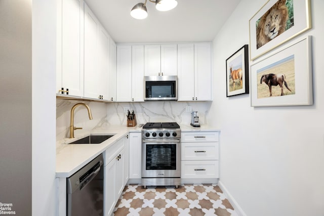 201 E 77th St Unit 7A, New York City, NY 10075 - kitchen with appliances with stainless steel finishes, backsplash, white cabinets, and light flooring