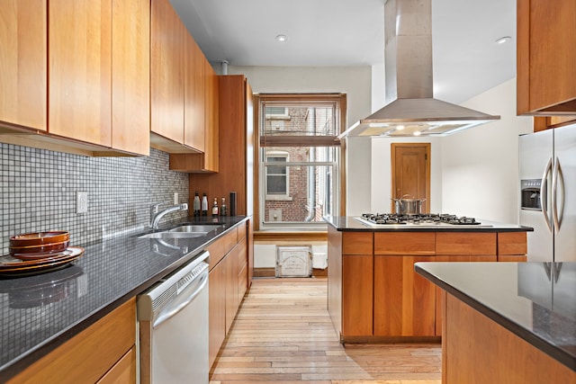 435 Convent Ave Unit 32, New York City, NY 10031 - kitchen with wall chimney range hood, appliances with stainless steel finishes, light wood-style floors, a sink, and decorative backsplash