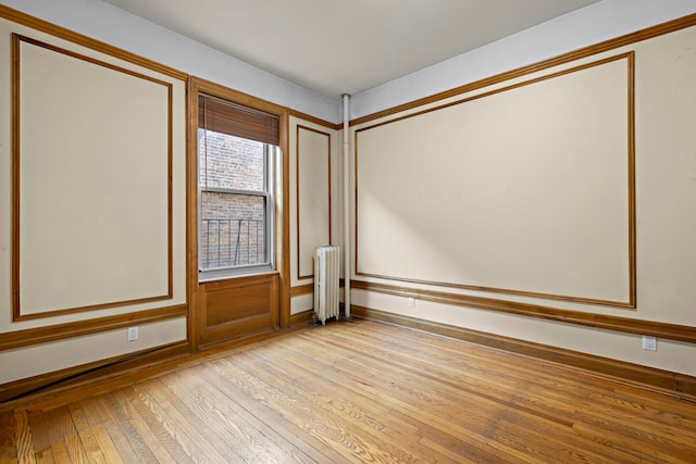 435 Convent Ave Unit 32, New York City, NY 10031 - empty room featuring radiator, light wood-type flooring, and baseboards