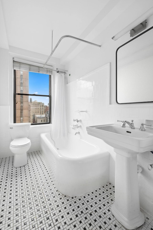 175 W 93rd St Unit 11B, New York City, NY 10025 - bathroom featuring tile walls and shower / bath combo with shower curtain