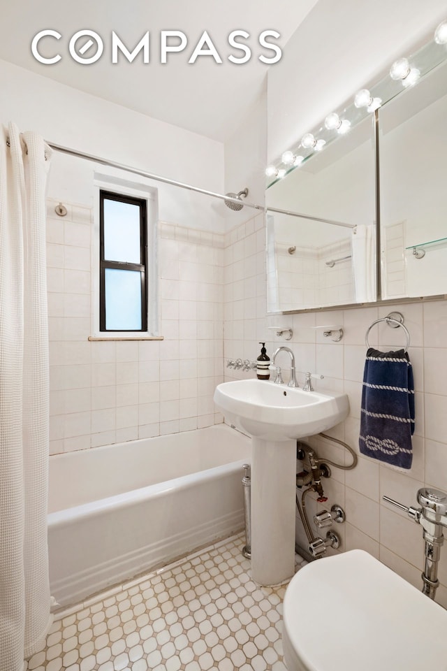 62 E 87th St Unit 3C, New York City, NY 10128 - bathroom featuring tile walls, shower / bath combo, and toilet
