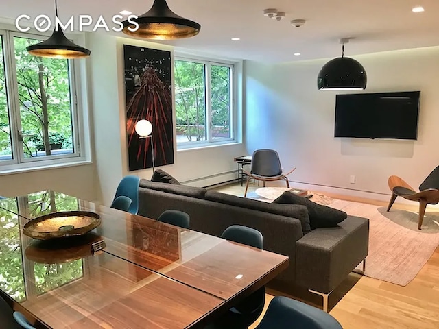 301 W 53rd St Unit 3I, New York City, NY 10019 - living room featuring plenty of natural light, wood finished floors, a baseboard radiator, and recessed lighting