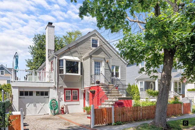 37 Centre St, New York City, NY 10464 - view of front of house with a chimney, an attached garage, and driveway