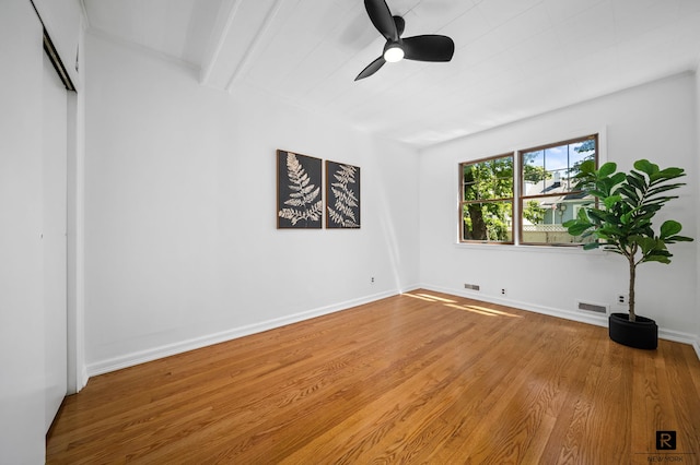 25 Bay St, New York City, NY 10464 - unfurnished bedroom featuring wood finished floors, a ceiling fan, and beamed ceiling