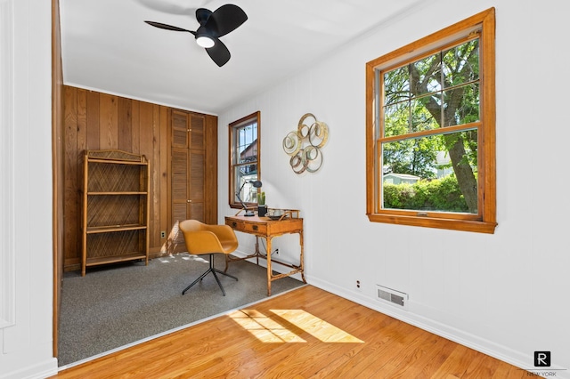 25 Bay St, New York City, NY 10464 - home office featuring plenty of natural light, a ceiling fan, and wood finished floors