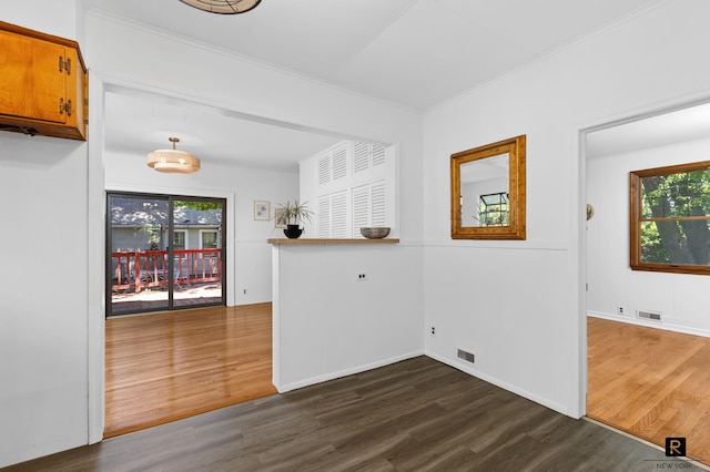 25 Bay St, New York City, NY 10464 - unfurnished dining area with dark wood-style flooring, healthy amount of natural light, and crown molding