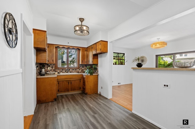 25 Bay St, New York City, NY 10464 - kitchen with brown cabinets, dark wood finished floors, backsplash, and light countertops