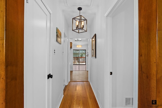 25 Bay St, New York City, NY 10464 - hall with light wood finished floors and a chandelier
