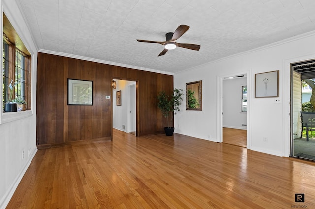 25 Bay St, New York City, NY 10464 - spare room with ceiling fan, crown molding, wood finished floors, and wood walls