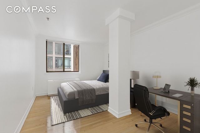 136-140 W 23rd St Unit 4Cc, New York City, NY 10011 - bedroom featuring ornamental molding, wood finished floors, baseboards, an office area, and ornate columns