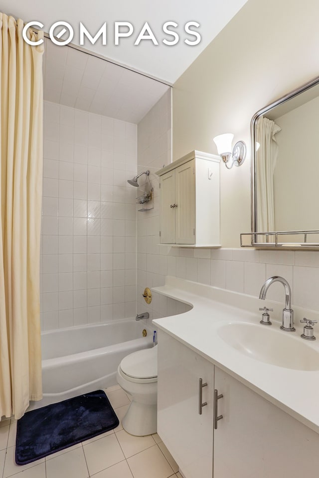 136-140 W 23rd St Unit 4Cc, New York City, NY 10011 - bathroom with vanity, shower / tub combo with curtain, tile patterned flooring, and toilet