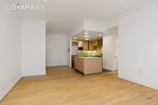 136-140 W 23rd St Unit 4Cc, New York City, NY 10011 - kitchen with decorative backsplash, ornamental molding, light wood-style flooring, high quality fridge, and baseboards