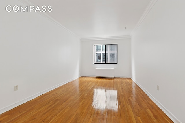 136-140 W 23rd St Unit 4Cc, New York City, NY 10011 - unfurnished room featuring ornamental molding, radiator, and light wood-type flooring