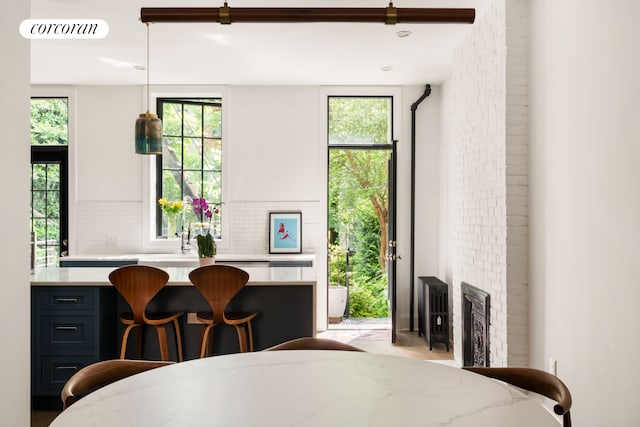 181 Waverly Ave, New York City, NY 11205 - dining area featuring plenty of natural light and a brick fireplace