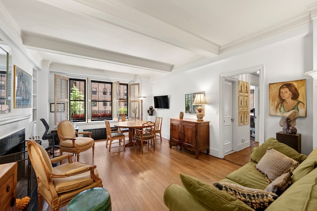 444 E 57th St Unit 5B, New York City, NY 10022 - living room featuring beam ceiling, hardwood / wood-style flooring, crown molding, and a fireplace
