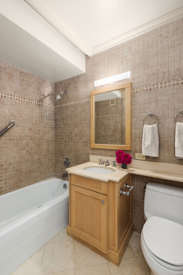 10 W 66th St Unit 30G, New York City, NY 10023 - full bathroom with tile walls, toilet, vanity, washtub / shower combination, and tile patterned flooring