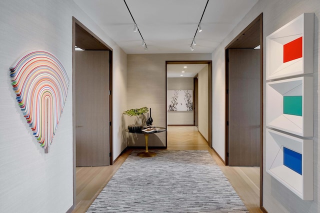 551 W 21st St Unit 16-B, New York City, NY 10011 - hallway with track lighting and light wood-style flooring