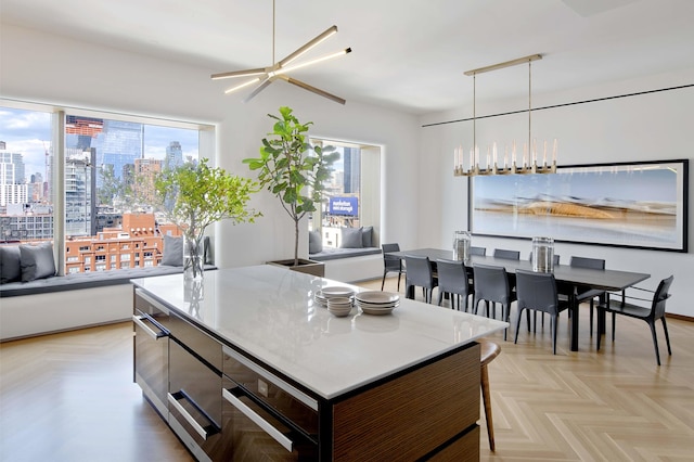 551 W 21st St Unit 16-B, New York City, NY 10011 - kitchen featuring oven, modern cabinets, a city view, a kitchen island, and hanging light fixtures