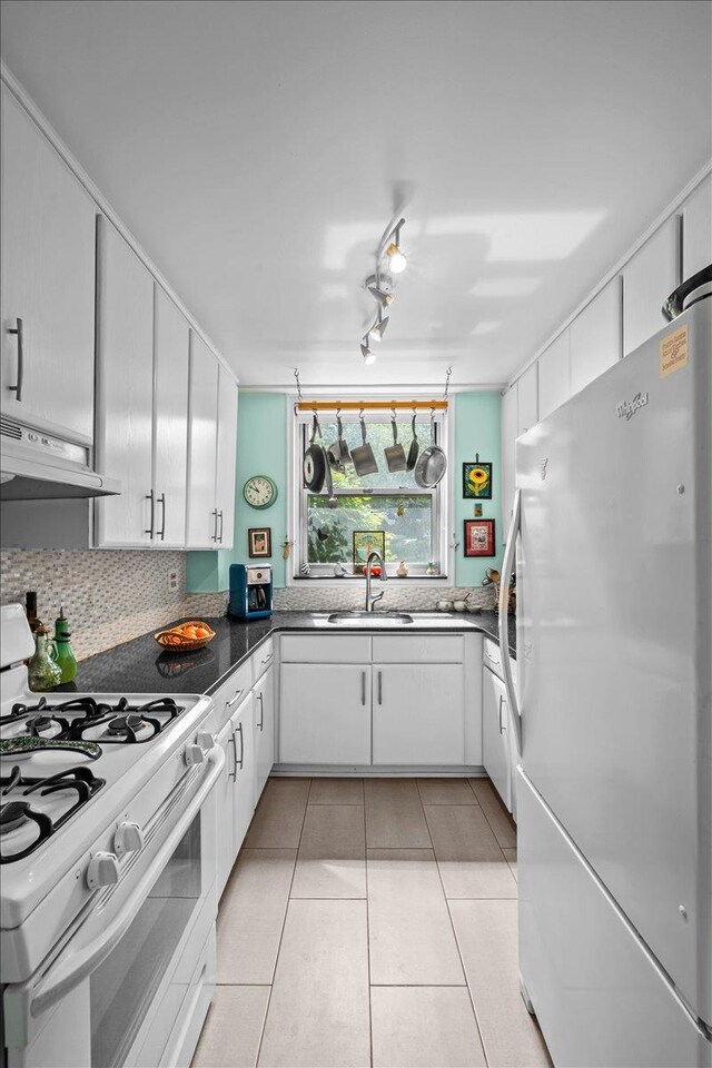 750 Kappock St Unit 1A, New York City, NY 10463 - kitchen with white appliances, a sink, under cabinet range hood, white cabinetry, and light tile patterned floors