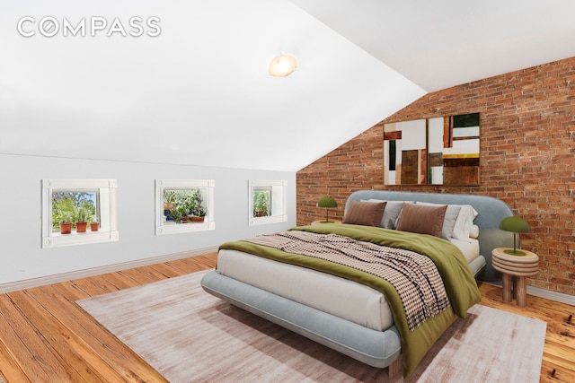 64 Clifton Place, New York City, NY 11238 - bedroom with brick wall, vaulted ceiling, wood finished floors, and baseboards