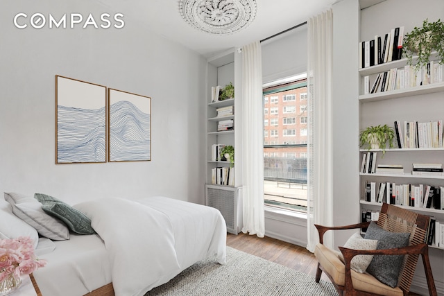 198 6th Ave, New York City, NY 10013 - bedroom with wood finished floors and a chandelier
