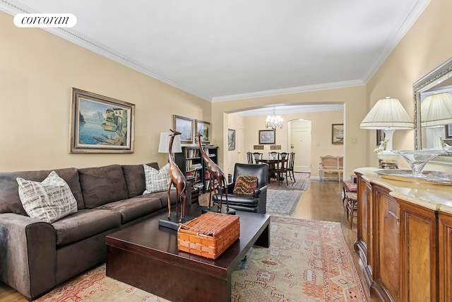 520 E 90th St Unit 2B, New York City, NY 10128 - living area with arched walkways, wood finished floors, crown molding, and a chandelier