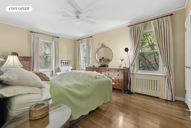 520 E 90th St Unit 2B, New York City, NY 10128 - bedroom with crown molding, multiple windows, wood finished floors, ceiling fan, and baseboards