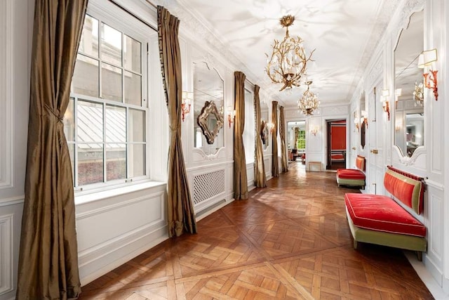 4 E 66th St Unit 4, New York City, NY 10065 - hallway featuring a chandelier, ornamental molding, and a decorative wall