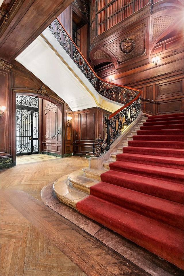 11 E 73rd St Unit 2Bc, New York City, NY 10021 - stairway with a high ceiling, wooden walls, and arched walkways