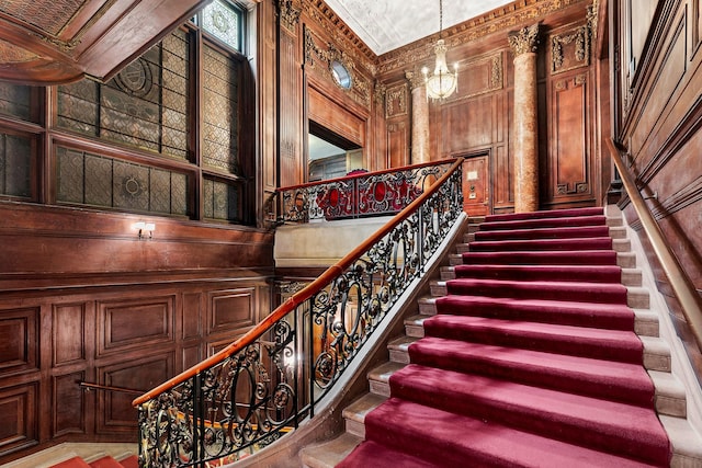 11 E 73rd St Unit 2Bc, New York City, NY 10021 - stairs featuring a chandelier and wood walls