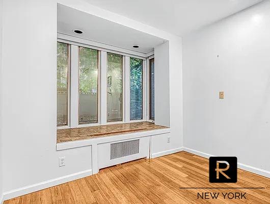233 E 31st St Unit A, New York City, NY 10016 - mudroom with baseboards, light wood-style flooring, and radiator heating unit