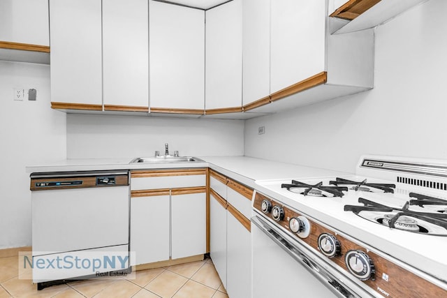 220 E 57th St Unit 4F, New York City, NY 10022 - kitchen with white appliances, a sink, light countertops, and white cabinetry